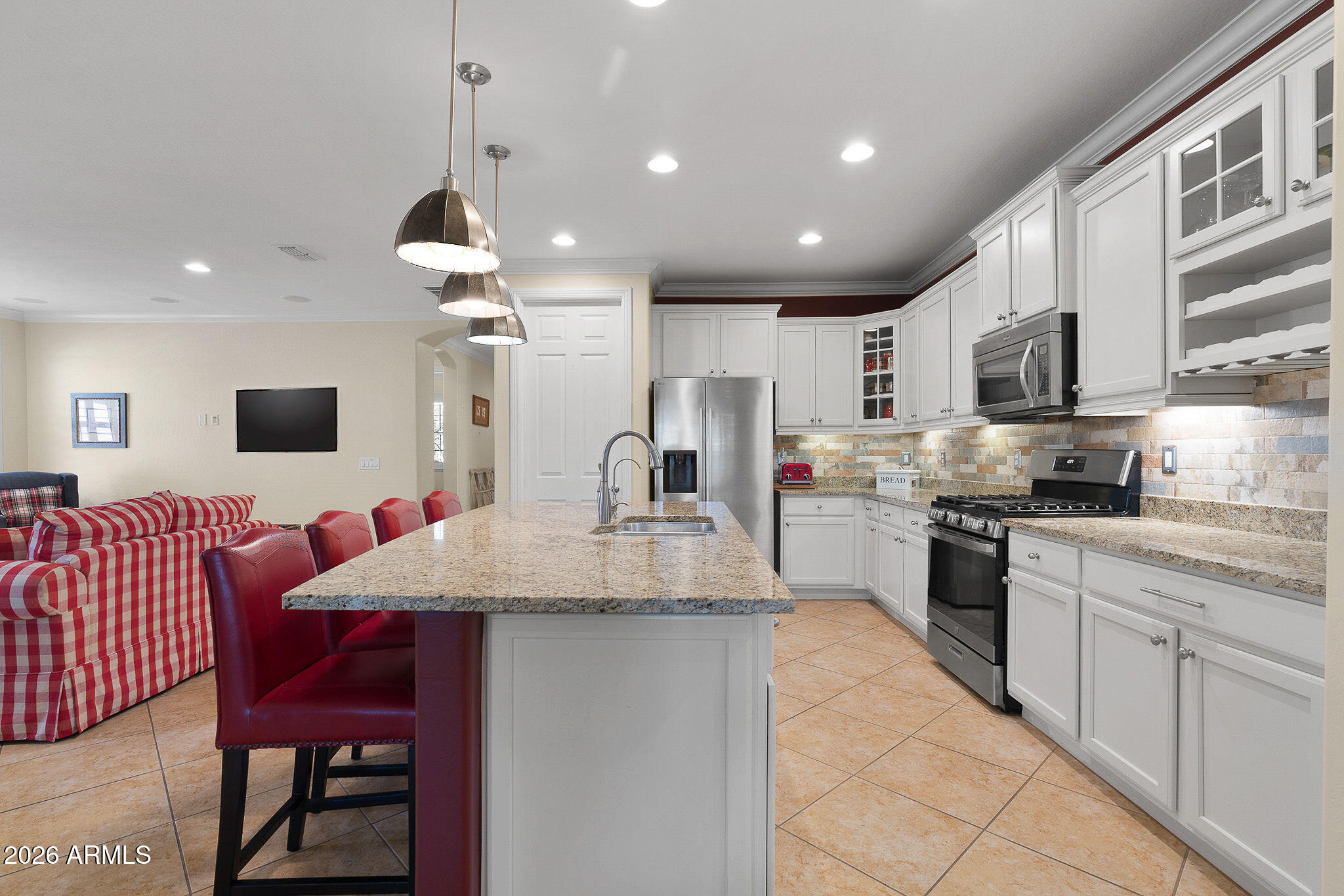 7337 West Silver Spring Way Florence, AZ 85132 - Photo 26 of 60 a kitchen with stainless steel appliances kitchen island granite countertop a sink and cabinets