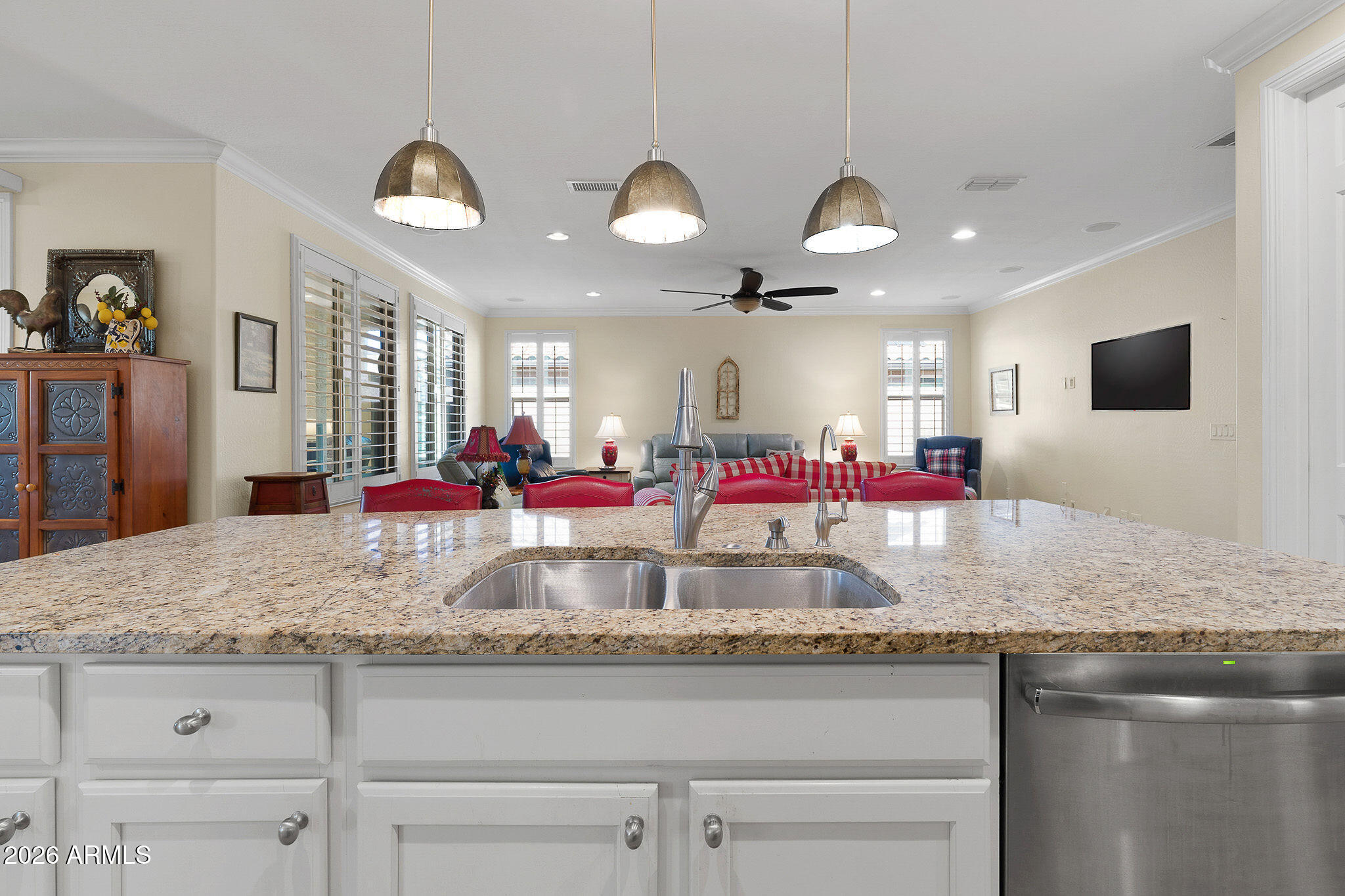 7337 West Silver Spring Way Florence, AZ 85132 - Photo 27 of 60 a view of a kitchen counter top space with granite countertop a sink counter space and living room