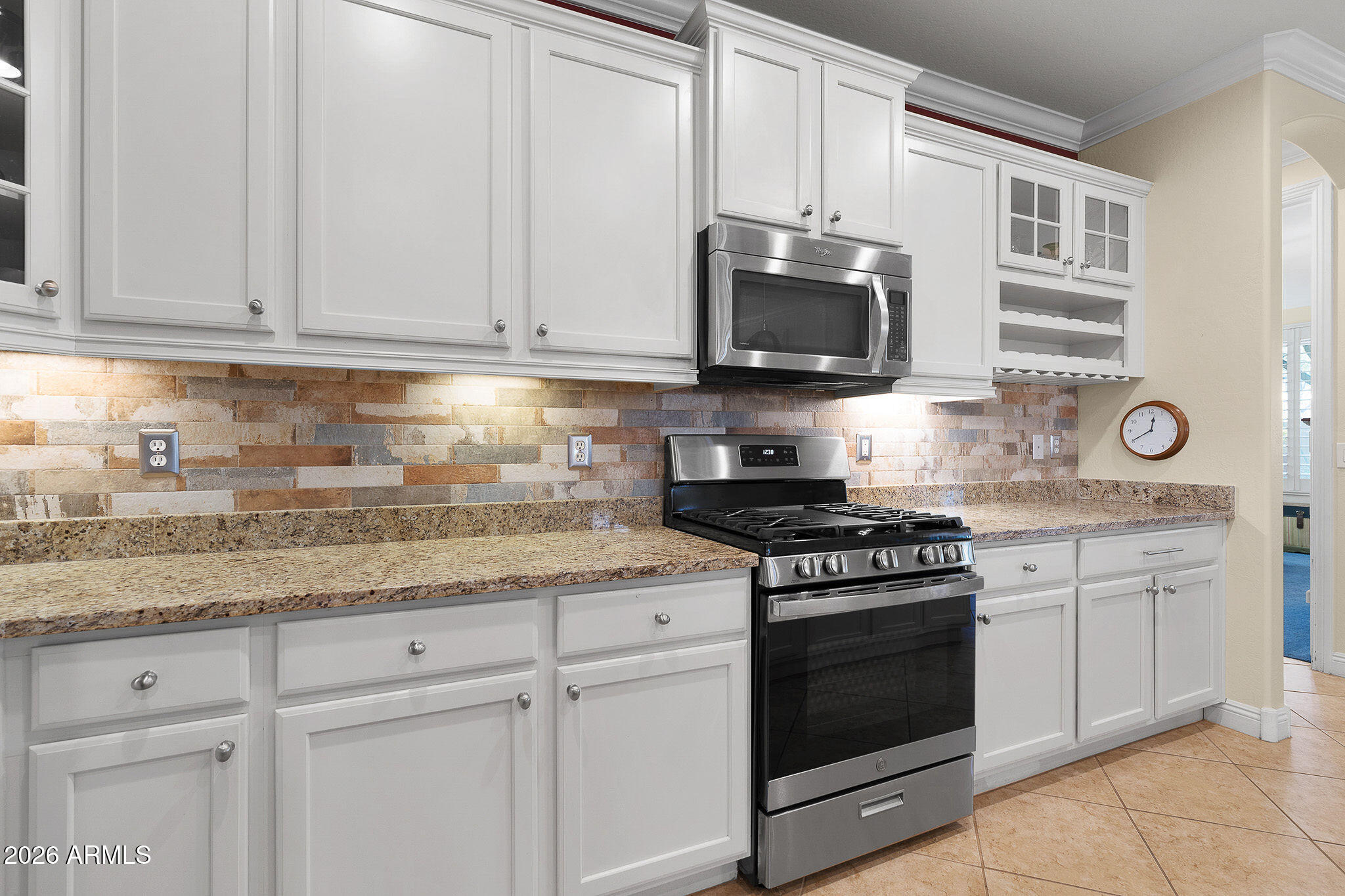 7337 West Silver Spring Way Florence, AZ 85132 - Photo 29 of 60 a kitchen with granite countertop white cabinets and stainless steel appliances