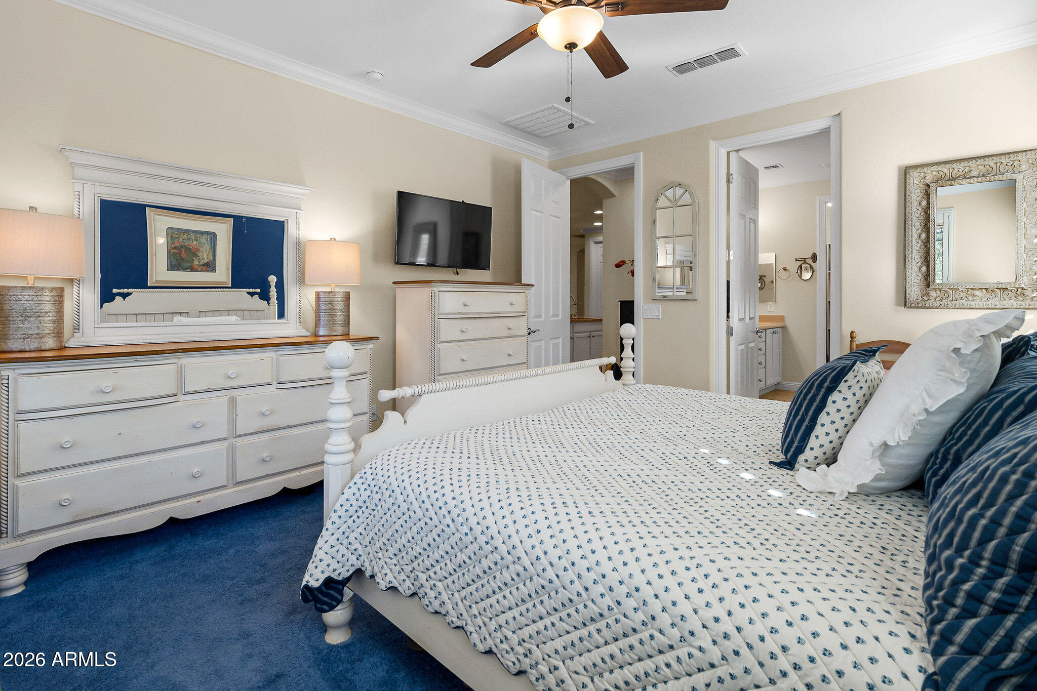 7337 West Silver Spring Way Florence, AZ 85132 - Photo 42 of 60 a bedroom with a large bed and a flat tv screen on dresser