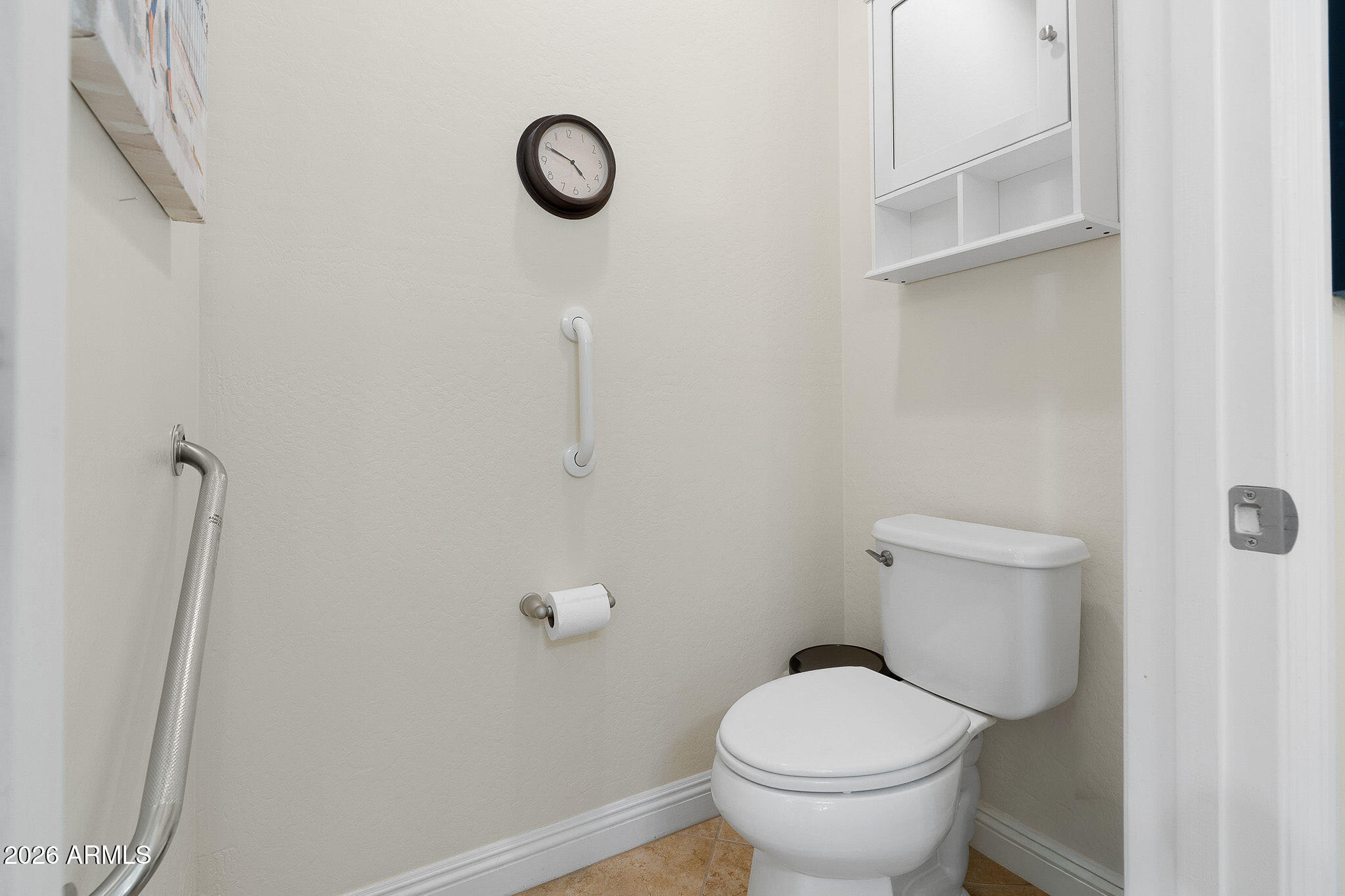 7337 West Silver Spring Way Florence, AZ 85132 - Photo 48 of 60 a white toilet sitting next to a wooden cabinets