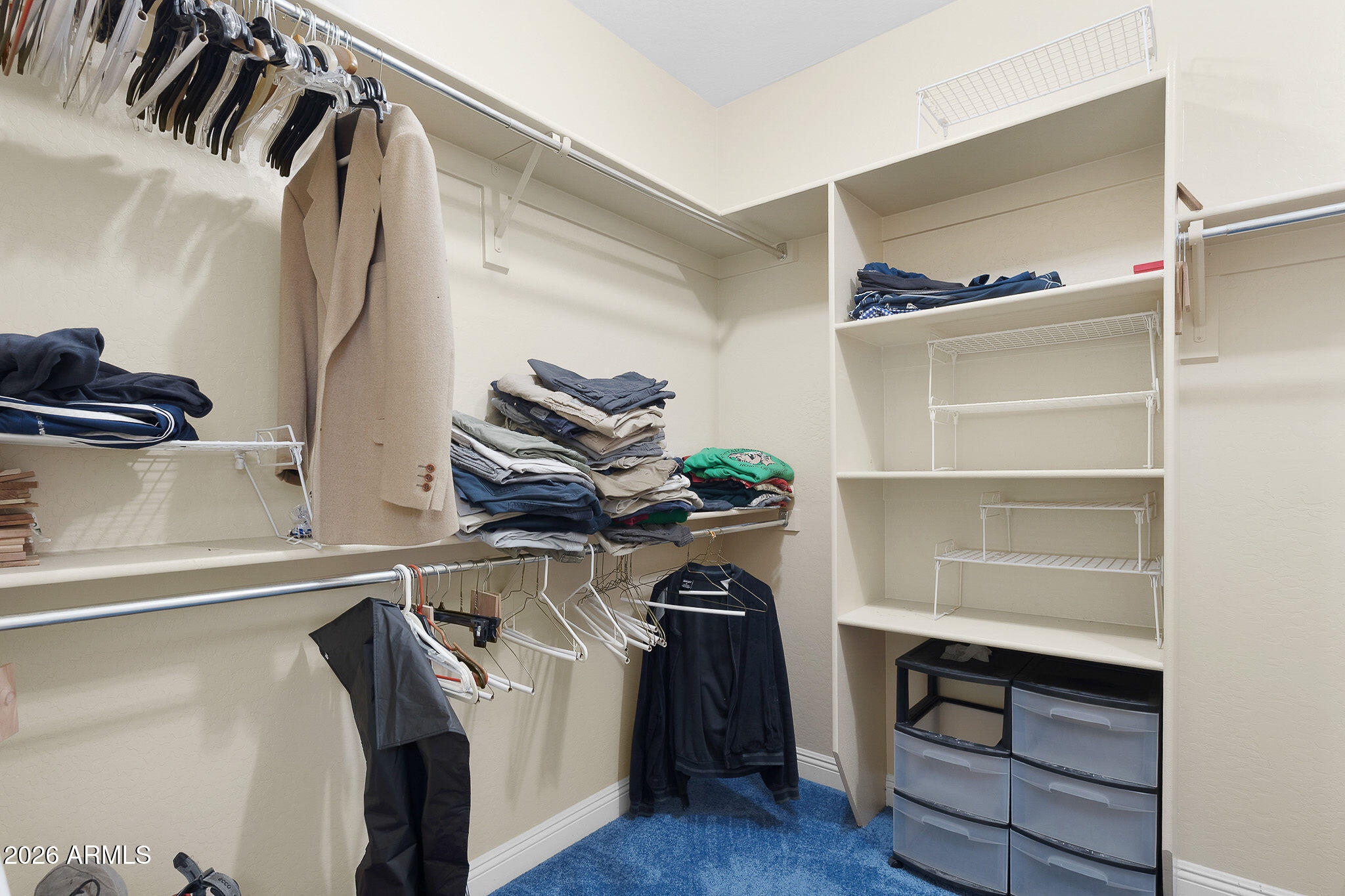 7337 West Silver Spring Way Florence, AZ 85132 - Photo 49 of 60 a view of walk in closet with clothes and shoes