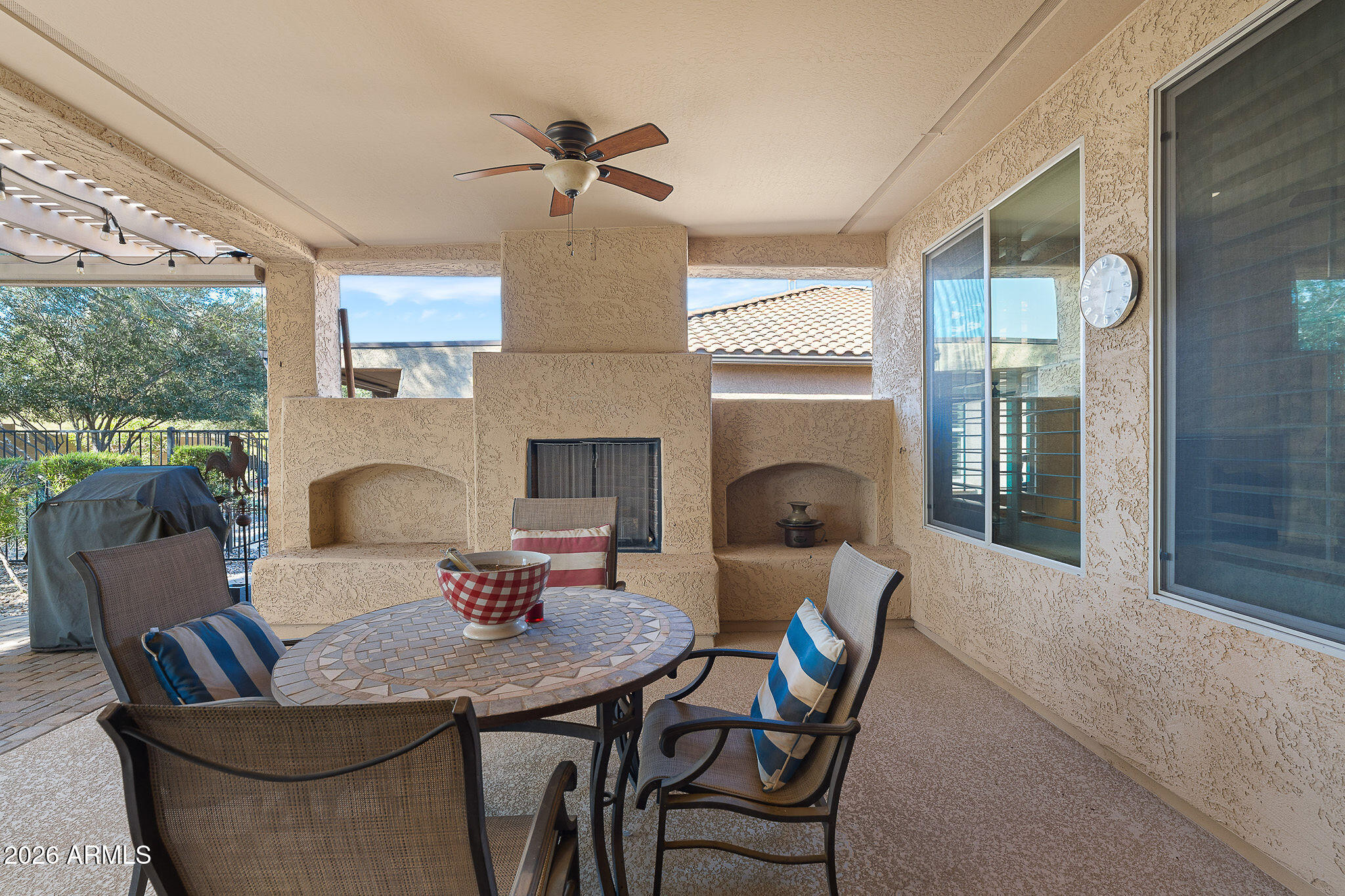 7337 West Silver Spring Way Florence, AZ 85132 - Photo 51 of 60 a living room with furniture a fireplace and a floor to ceiling window