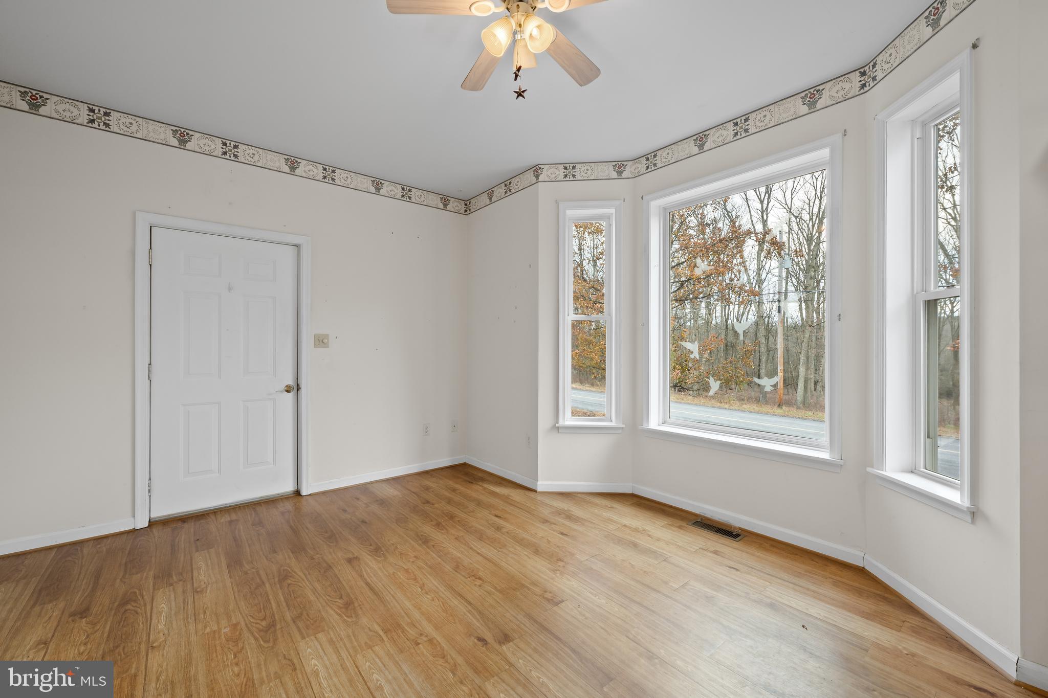 1 Pinewood Circle Hazleton, PA 18202 - Photo 13 of 33 a view of an empty room with a window and wooden floor