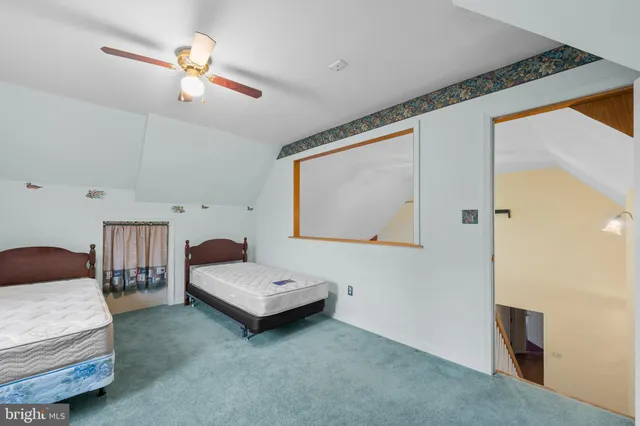 a bedroom with bed and window