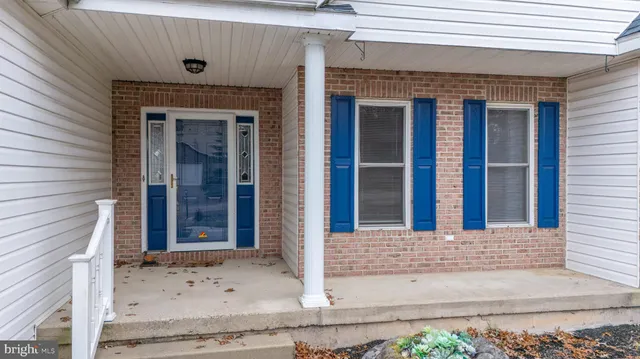 a view of a brick house with large windows