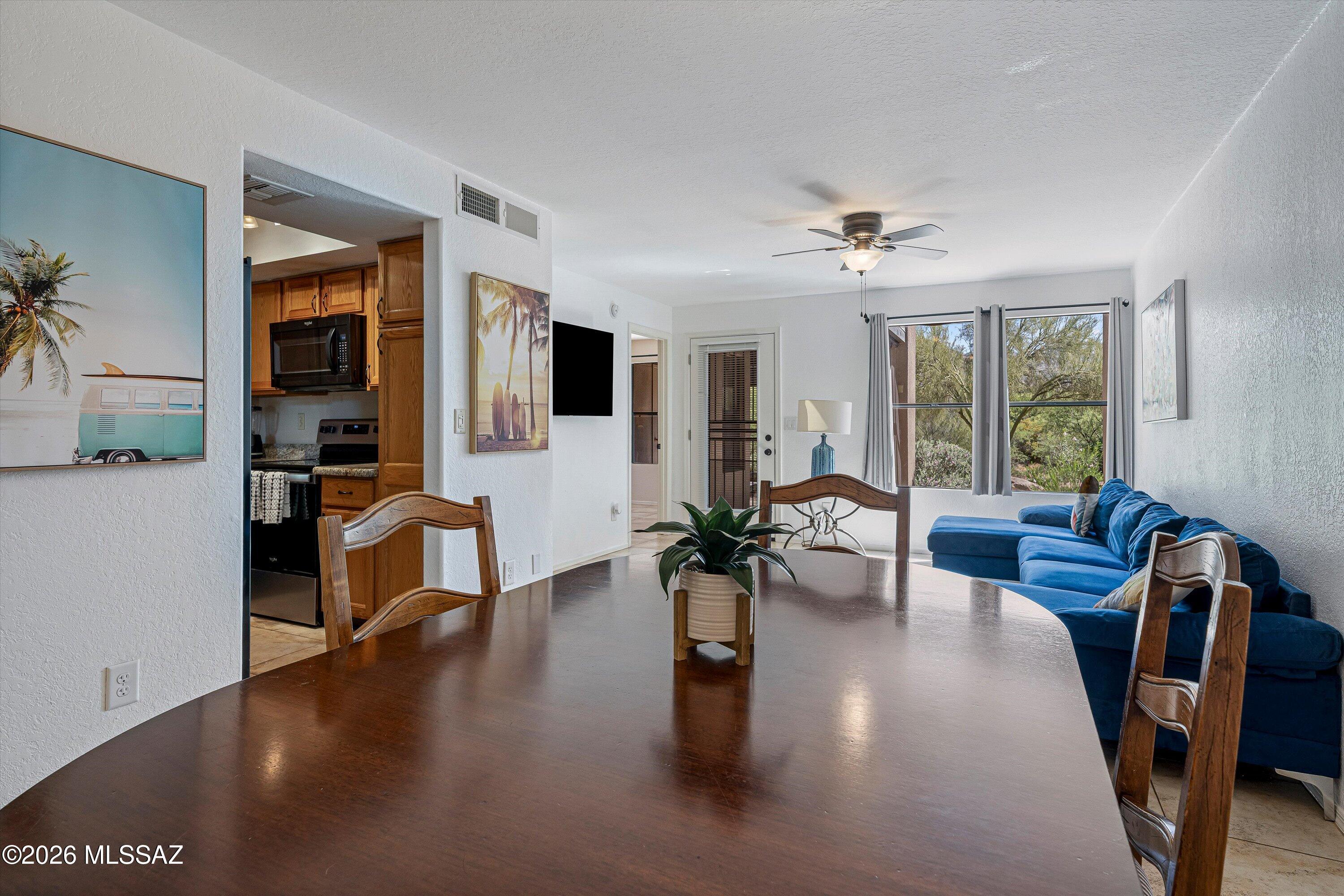5800 North Kolb Road, Unit 5125 Tucson, AZ 85750 - Photo 5 of 34 a living room with fireplace furniture and a large window