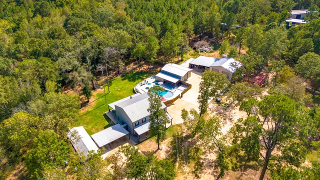 an aerial view of a house with swimming pool and outdoor space