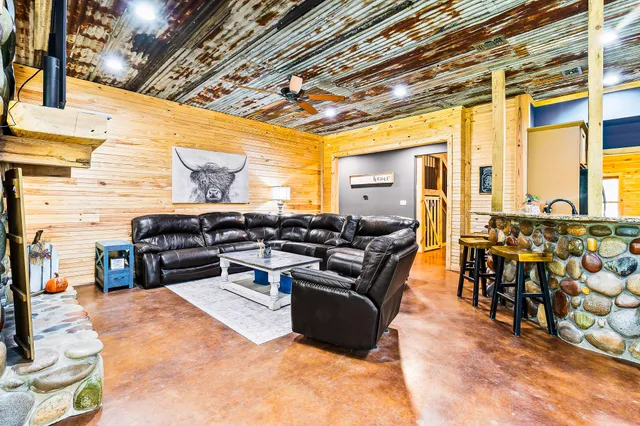 a living room with furniture and a chandelier