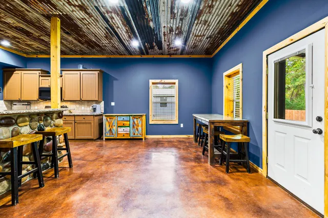 a dining room with furniture and wooden floor