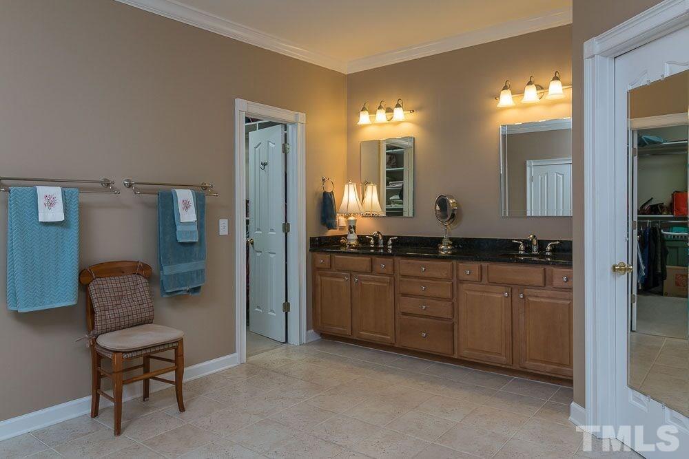 3920 Bentley Bridge Road Raleigh, NC 27612 - Photo 12 of 20 a spacious bathroom with a mirror and a sink
