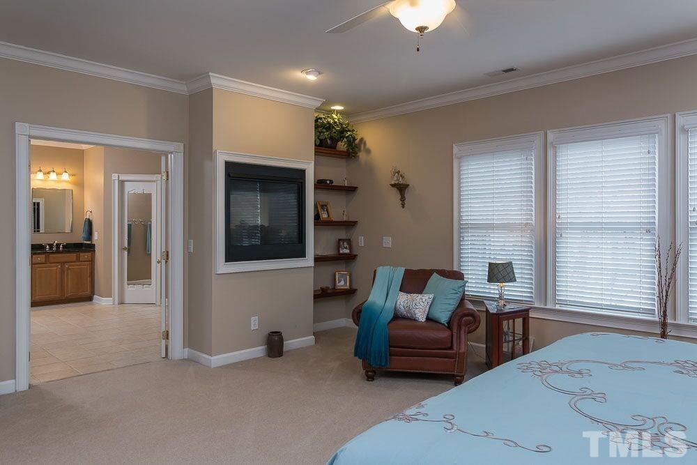 3920 Bentley Bridge Road Raleigh, NC 27612 - Photo 9 of 20 a living room with furniture and a fireplace