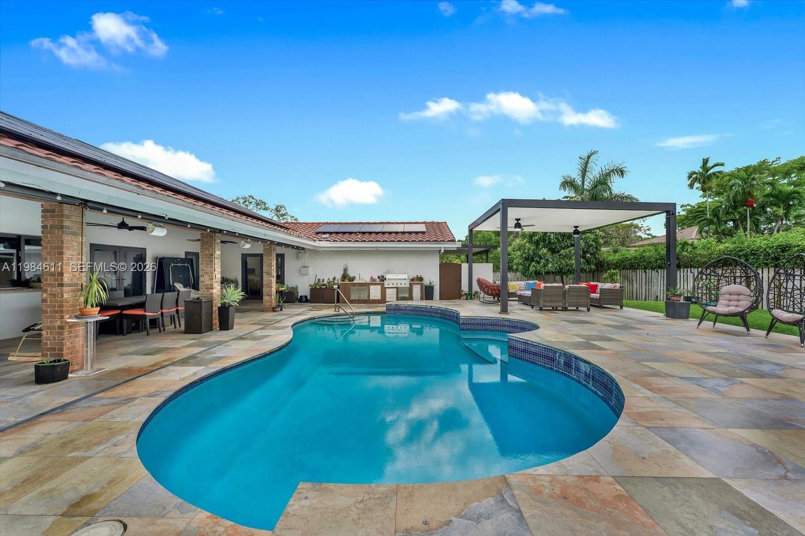 10126 Southwest 93rd Place Miami, FL 33176 - Photo 15 of 27 a view of a swimming pool with outdoor seating