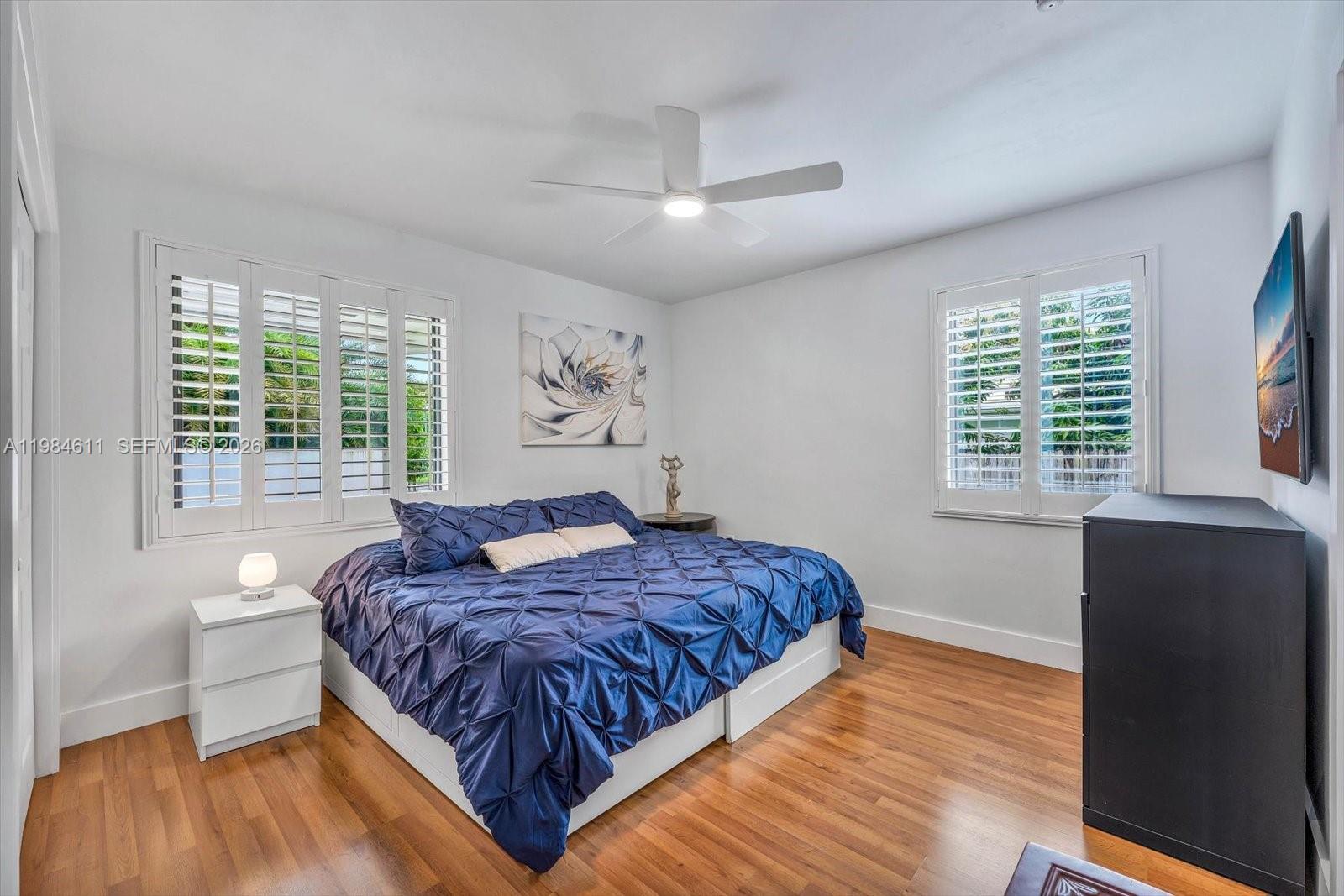 10126 Southwest 93rd Place Miami, FL 33176 - Photo 21 of 27 a bedroom with a large bed and a large window