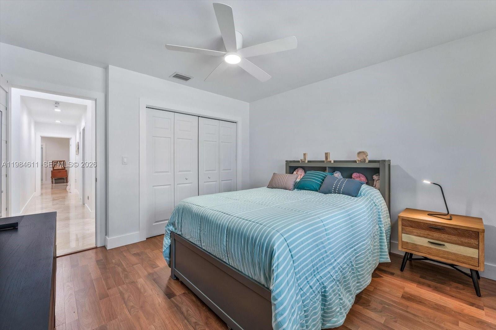 10126 Southwest 93rd Place Miami, FL 33176 - Photo 23 of 27 a bedroom with a bed and wooden floor