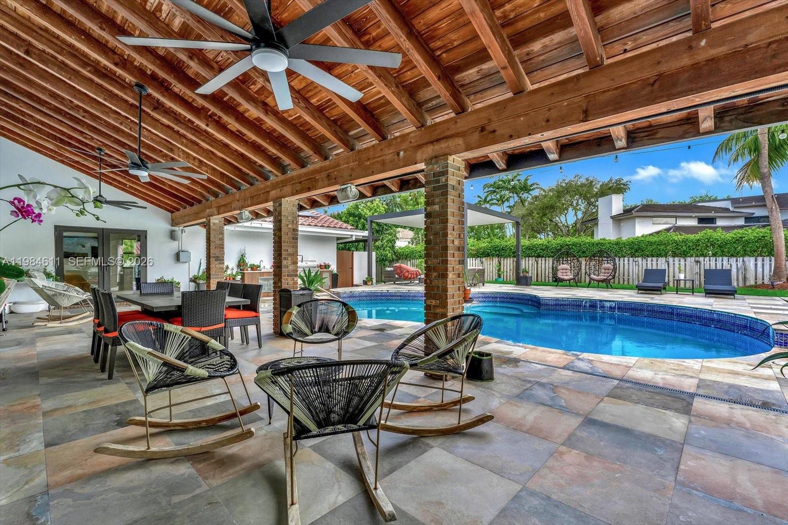 10126 Southwest 93rd Place Miami, FL 33176 - Photo 4 of 27 a building outdoor space with patio furniture and potted plants