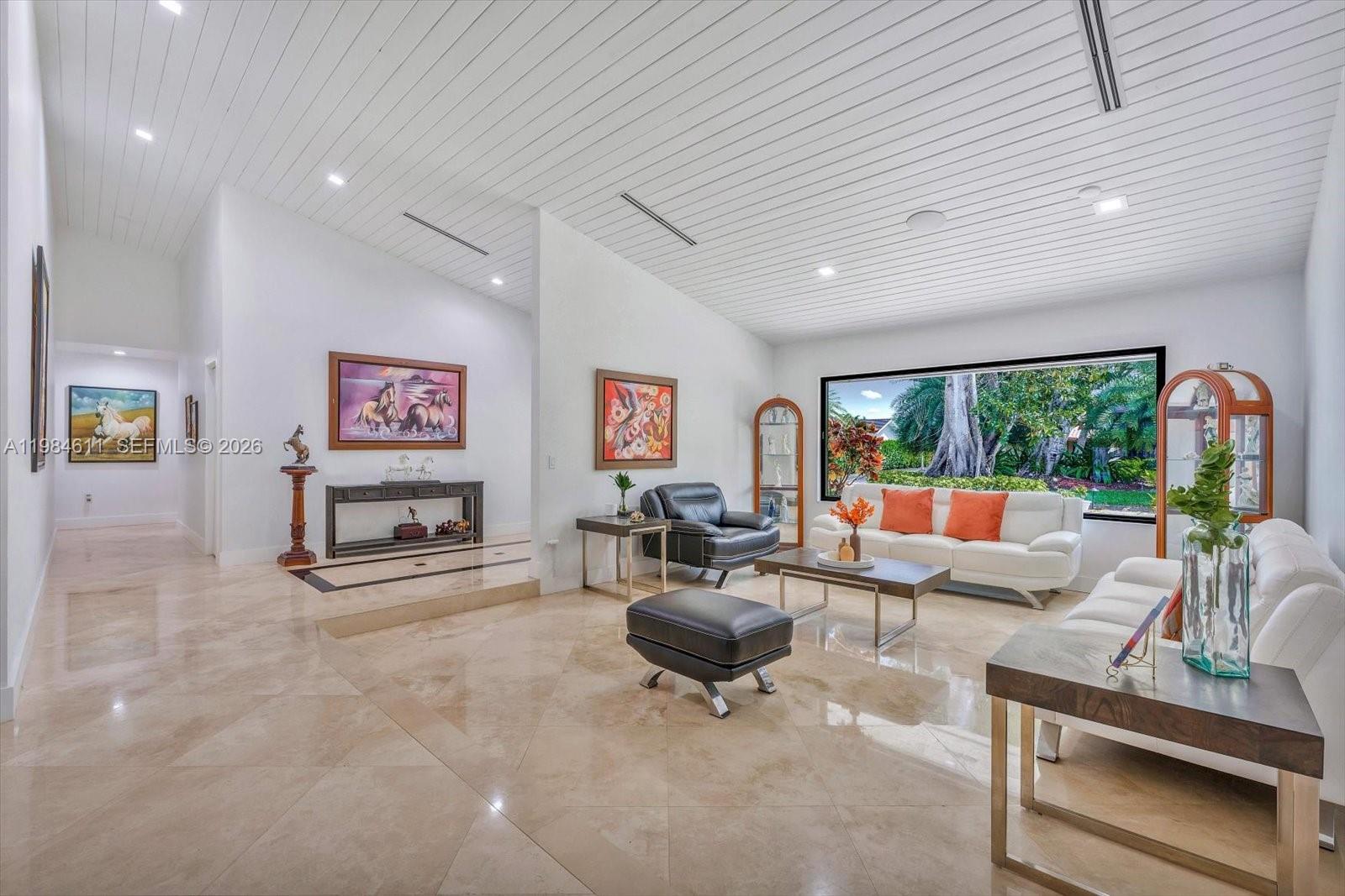 10126 Southwest 93rd Place Miami, FL 33176 - Photo 6 of 27 a living room with furniture and a flat screen tv
