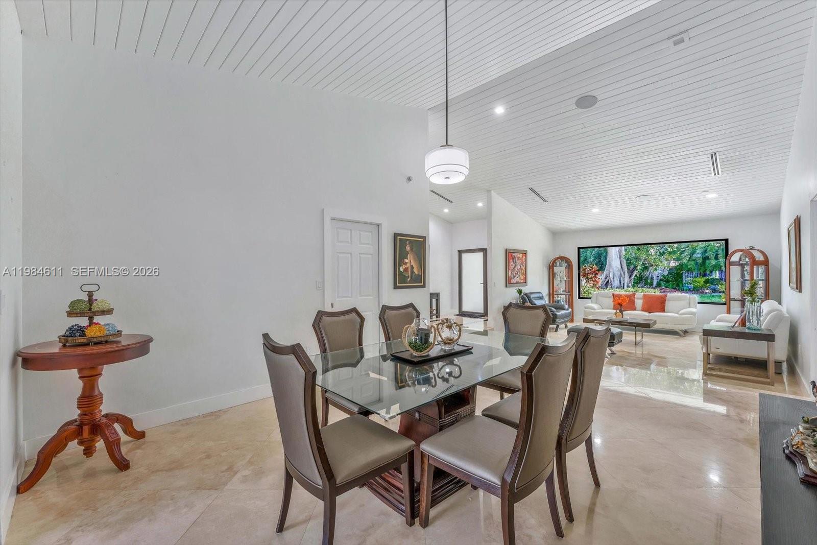 10126 Southwest 93rd Place Miami, FL 33176 - Photo 7 of 27 a view of a dining room with furniture and a chandelier