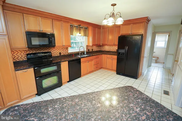a kitchen with a sink a stove and refrigerator