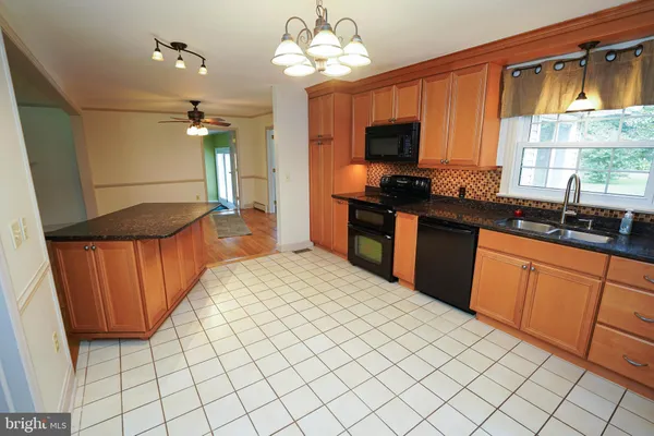 a view of kitchen with furniture wooden floor and window