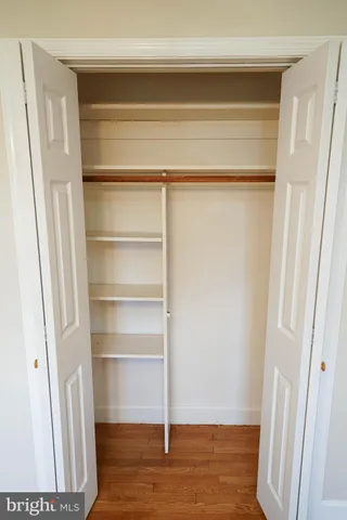 front view of a house with a yard and trees