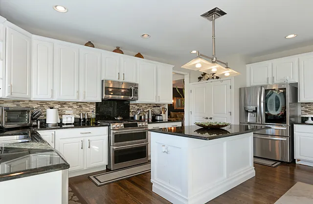 a kitchen with a sink stainless steel appliances and cabinets