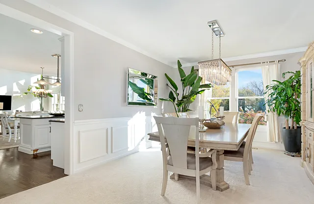 a dining room filled chandelier and fireplace