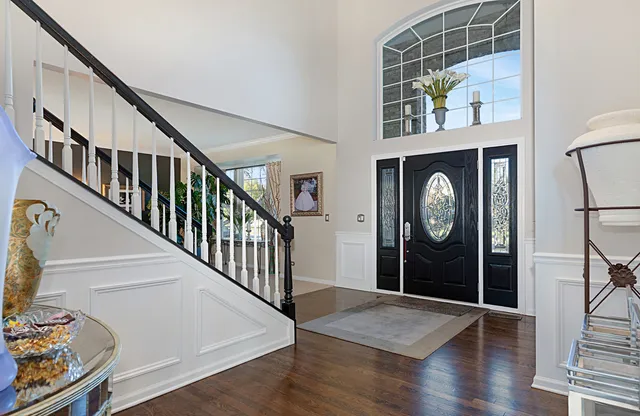 a view of a hallway with wooden floor and windows