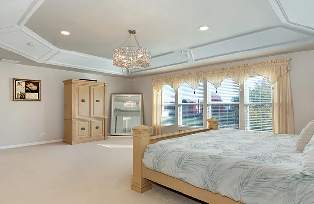 a bedroom with a large bed and a dresser