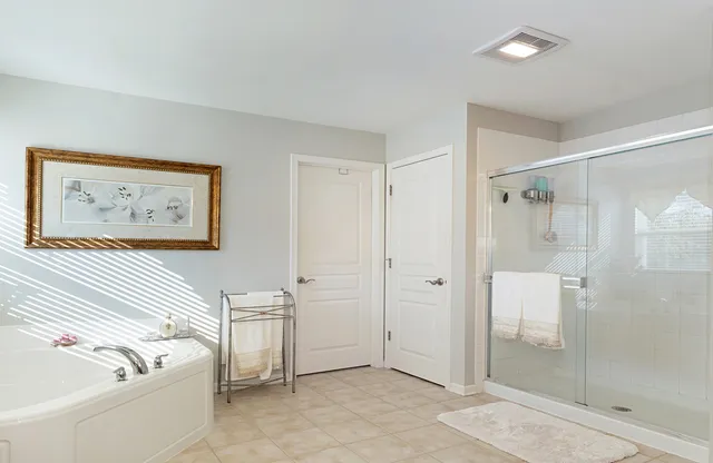 a view of walk in closet with clothes