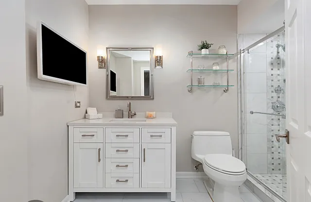 a bathroom with a shower a toilet and a shower