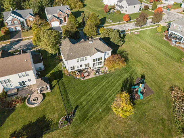 a backyard of a house with barbeque oven table and chairs