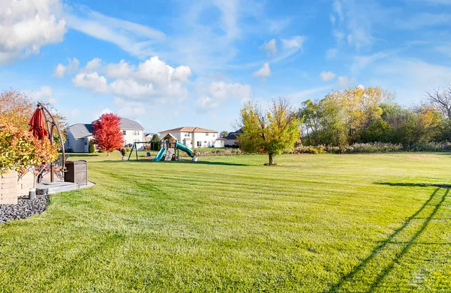 a view of a patio with couches and table and chairs and potted plants