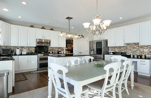 a kitchen with kitchen island granite countertop a sink a center island and cabinets