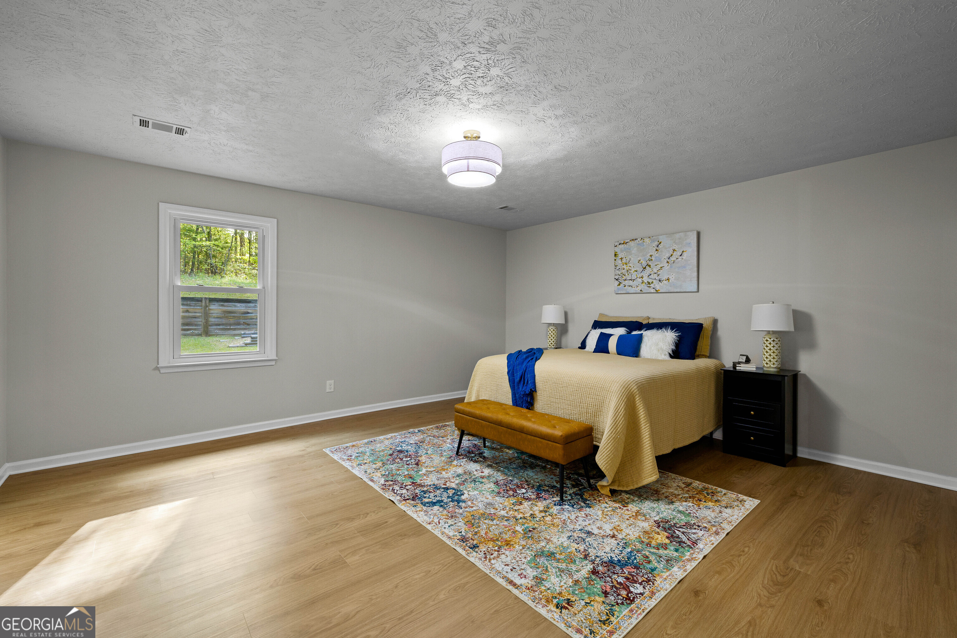 40 River Point Drive LaGrange, GA 30240 - Photo 13 of 22 a bed sitting in a bedroom next to a window with a rug