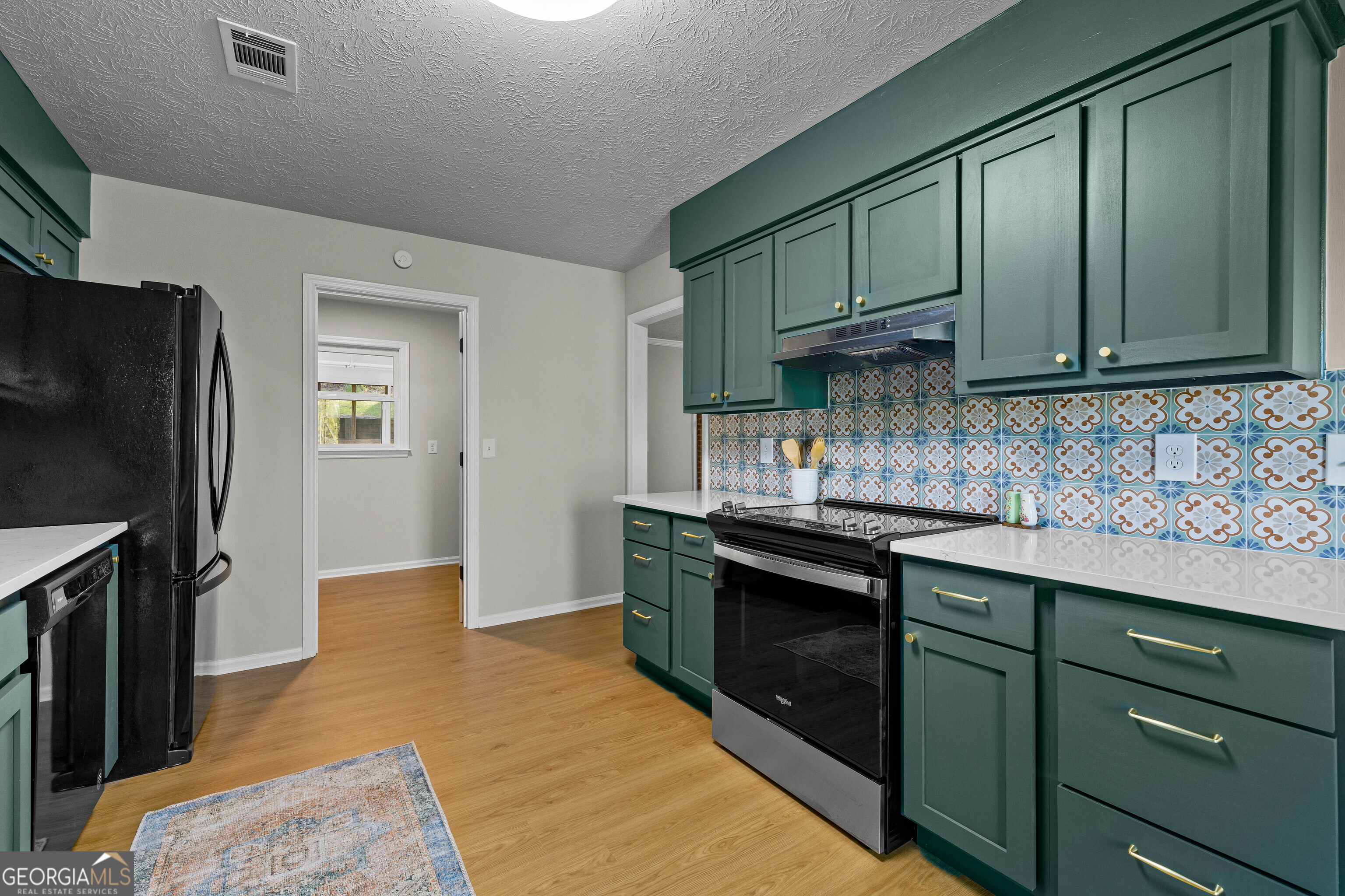 40 River Point Drive LaGrange, GA 30240 - Photo 7 of 22 a kitchen with stainless steel appliances granite countertop wooden cabinets a refrigerator a sink and dishwasher