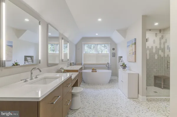 a kitchen with stainless steel appliances granite countertop a sink and a refrigerator