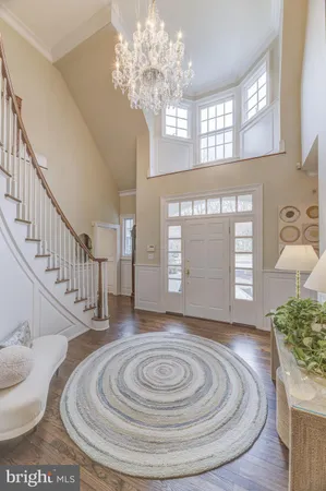 a dining room with furniture a chandelier and wooden floor