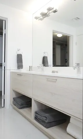 a bathroom with a shower sink vanity mirror and toilet