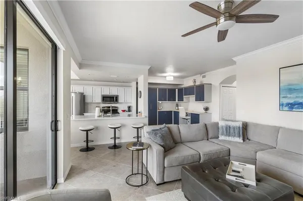 a view of living room kitchen with furniture and a ceiling fan