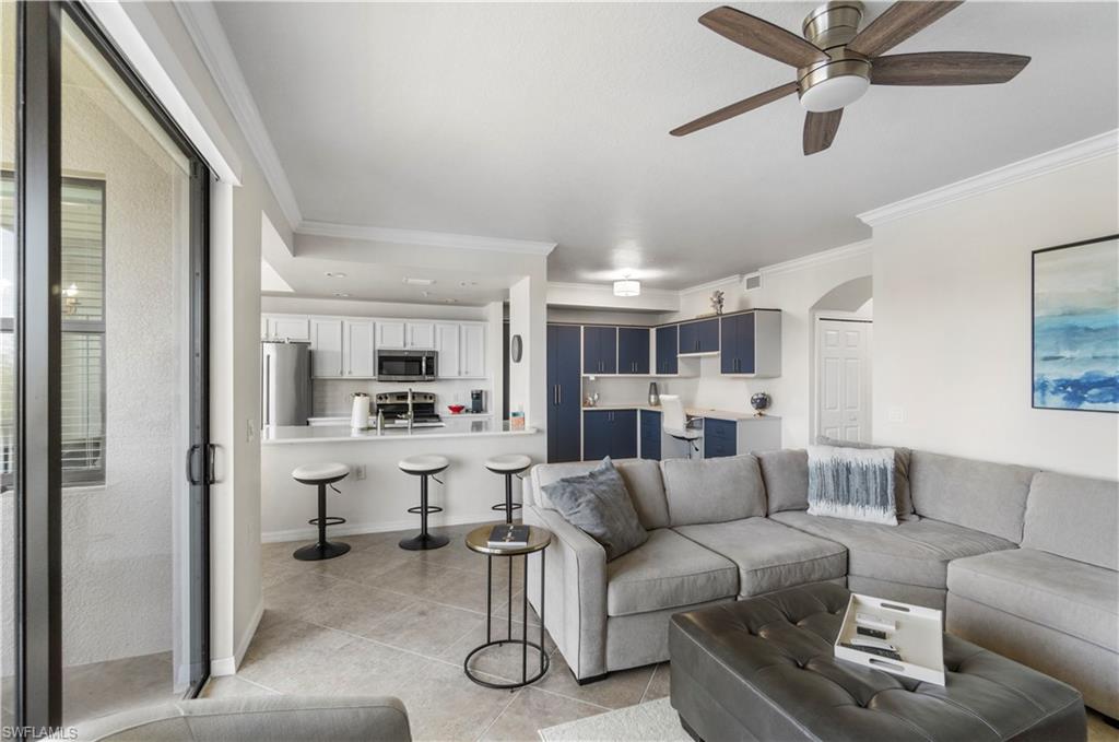 9820 Giaveno Circle, Unit 1422 Naples, FL 34113 - Photo 4 of 36 a view of living room kitchen with furniture and a ceiling fan