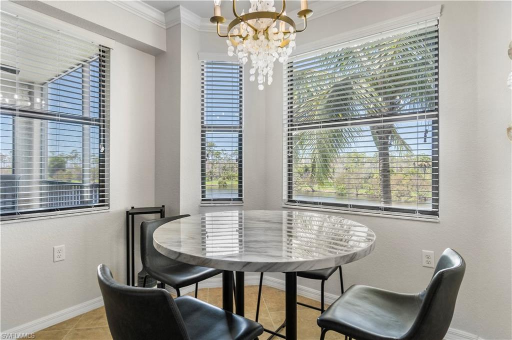 9820 Giaveno Circle, Unit 1422 Naples, FL 34113 - Photo 7 of 36 a view of a dining room with furniture and windows