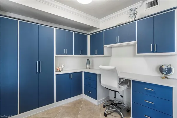 a view of cabinets with chair and wooden door
