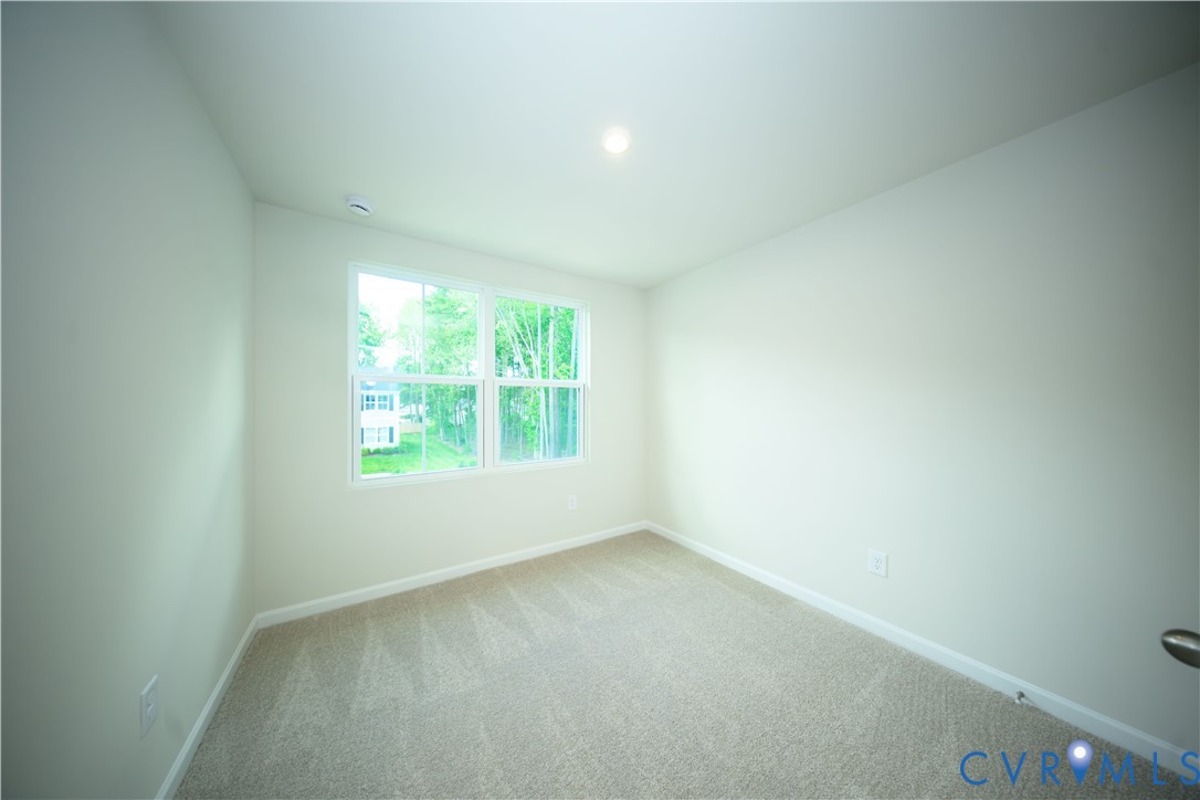 1121 Canterbury Ridge Road Richmond, VA 23224 - Photo 39 of 53 Neutral-toned carpeting and light-colored walls de