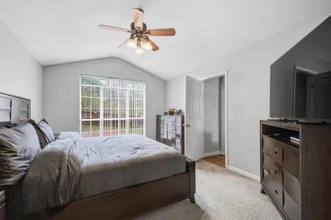 a bedroom with a large bed and a window