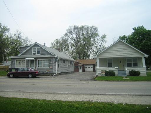 720 Montgomery Road Montgomery, IL 60538 - Photo 1 of 1 a front view of a house with a garden and plants