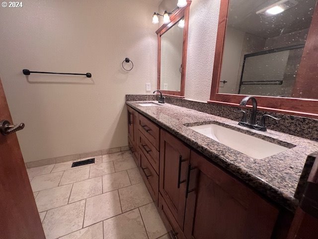 2890 Warren Street Eugene, OR 97405 - Photo 22 of 46 a bathroom with a granite countertop sink and a mirror