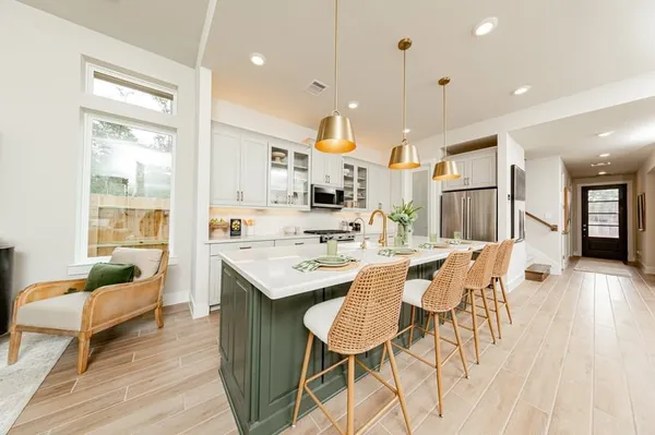 a large kitchen with a table and chairs