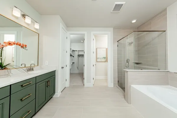 a spacious bathroom with a shower sink double vanity and mirror
