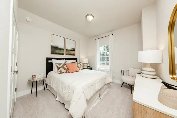 a bedroom with a bed and a lamp